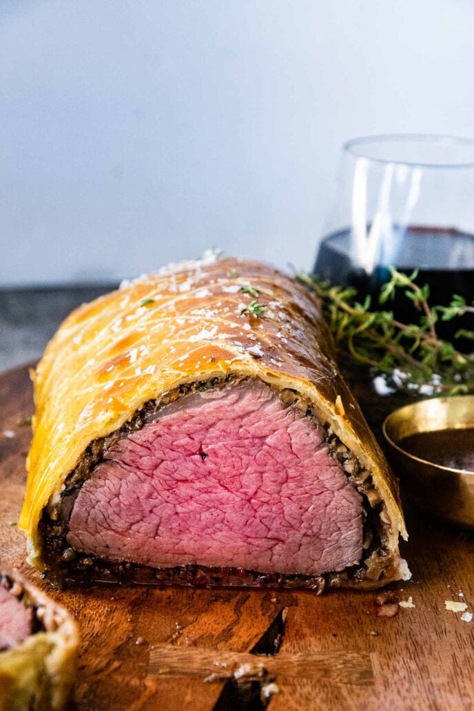 Beef Wellington fully cooked on cutting board