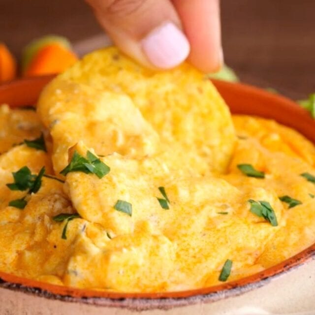 Slow Cooker Buffalo Chicken Dip with hand dipping chip