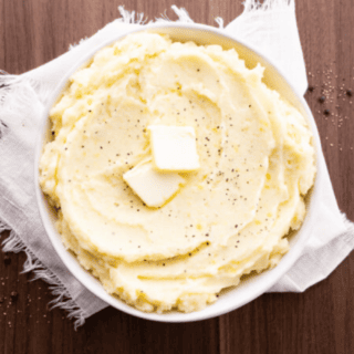 Potatoes in serving dish with butter on top