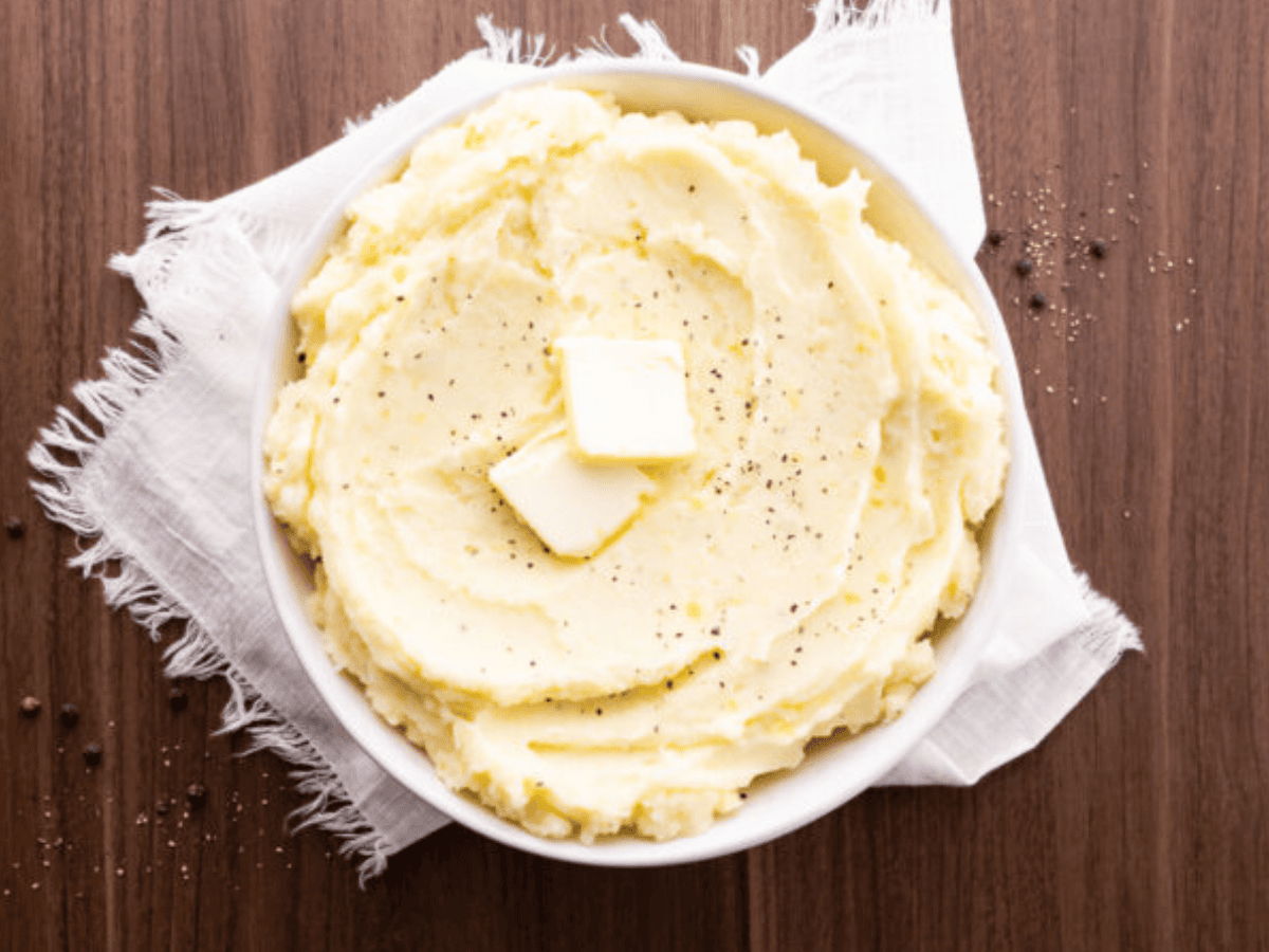 Potatoes in serving dish with butter on top