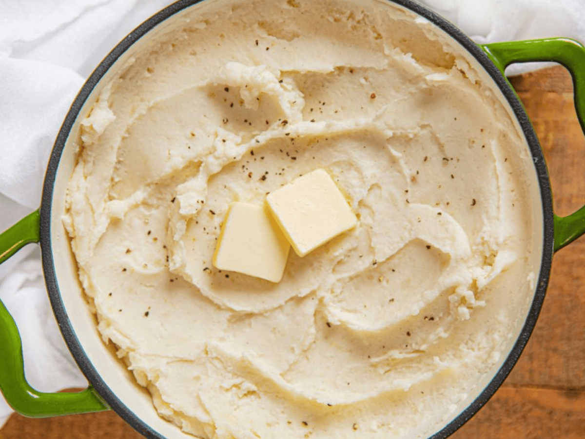 Top view of Potatoes in pot with slice of butter