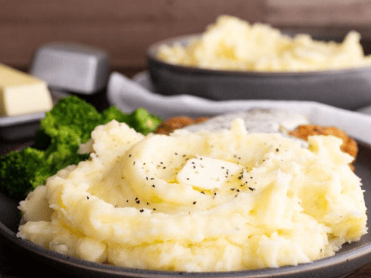 Side view showing potatoes served on plate with butter