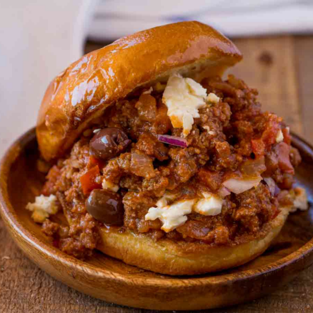 hand holding plate with sloppy joe