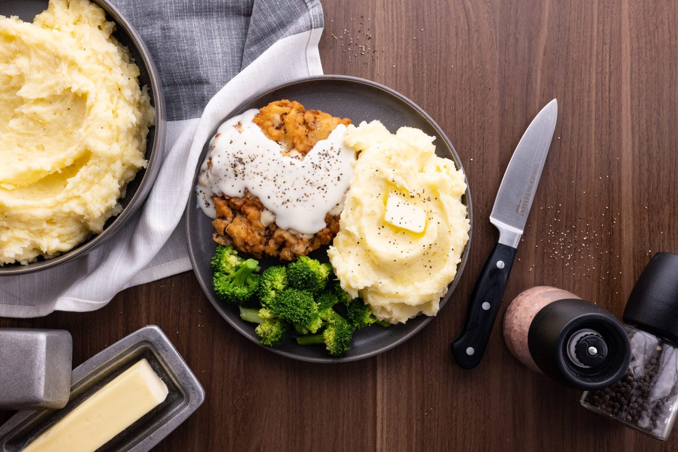 Easy Mashed Potatoes on plate with broccoli and chicken fried steak with gravy