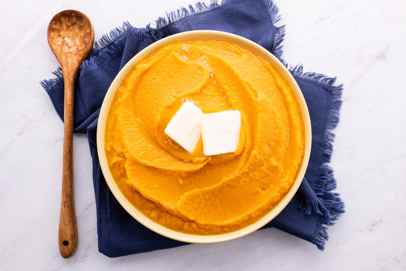 Mashed Sweet Potatoes in bowl with butter