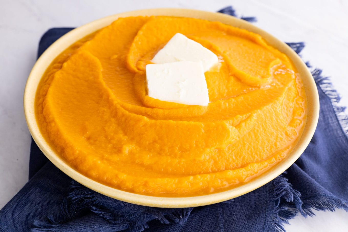 Mashed Sweet Potatoes in bowl with butter