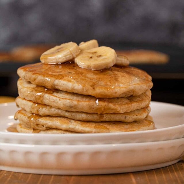 Banana Pancakes in stack with maple syrup
