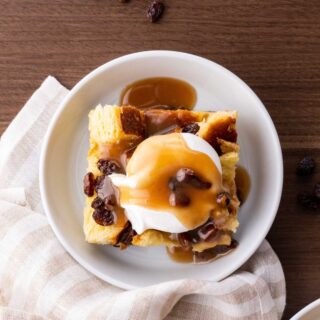 Bread Pudding in bowl with whipped cream and caramel sauce