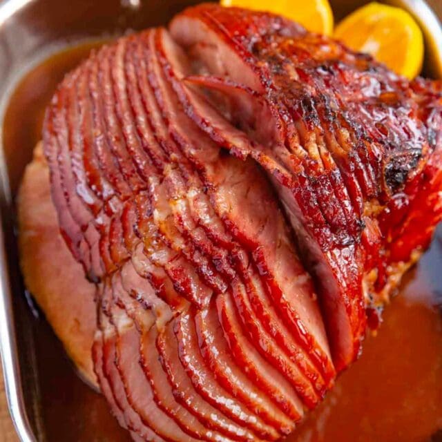 Brown Sugar Ham Glaze baked glazed ham in pan with orange slices