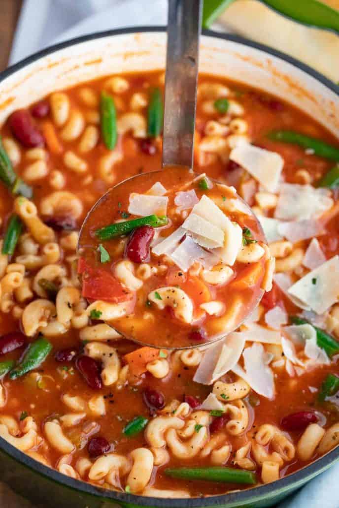 ladle taking soup from pot 
