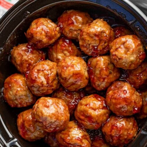 Zoomed out cooked meatballs in sauce.