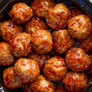 Cooked meatballs in sauce in a crockpot.