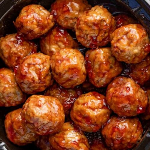 Cooked meatballs in sauce in a crockpot.