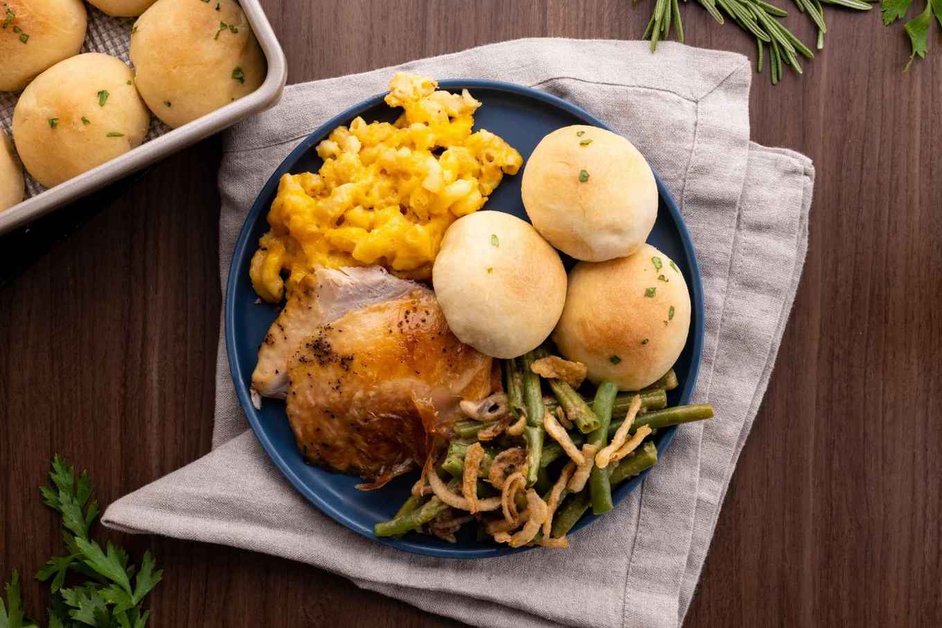 Dinner rolls on plate with green beans and chicken