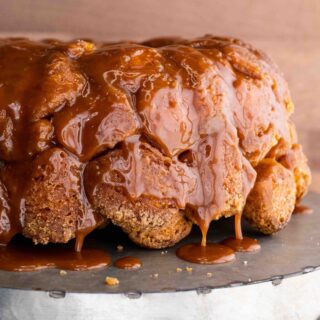 aerial view of dough stacked up on top of each other shaped in a bundt pan with drizzling on a table