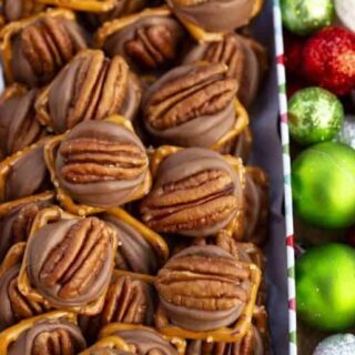 Pretzel mini Turtles in a Christmas Box with green ornaments on side of the box.