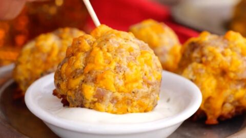 Sausage Balls on toothpick dipped in Ranch dressing