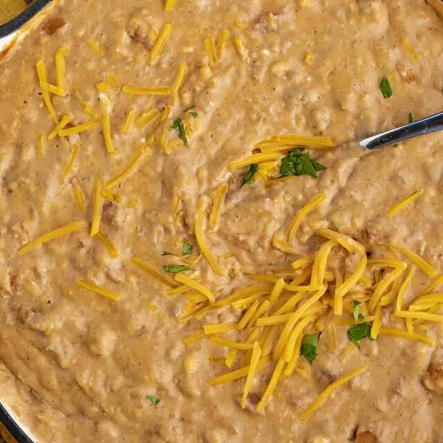 Bean and Cheese Dip in a pan, being stirred