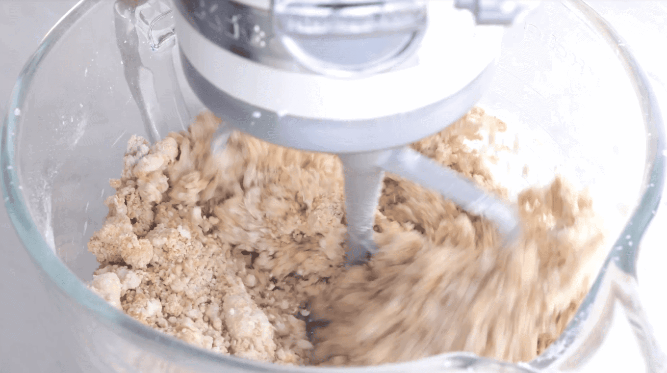 Mixing peanut butter with dry ingredients in a stand mixer