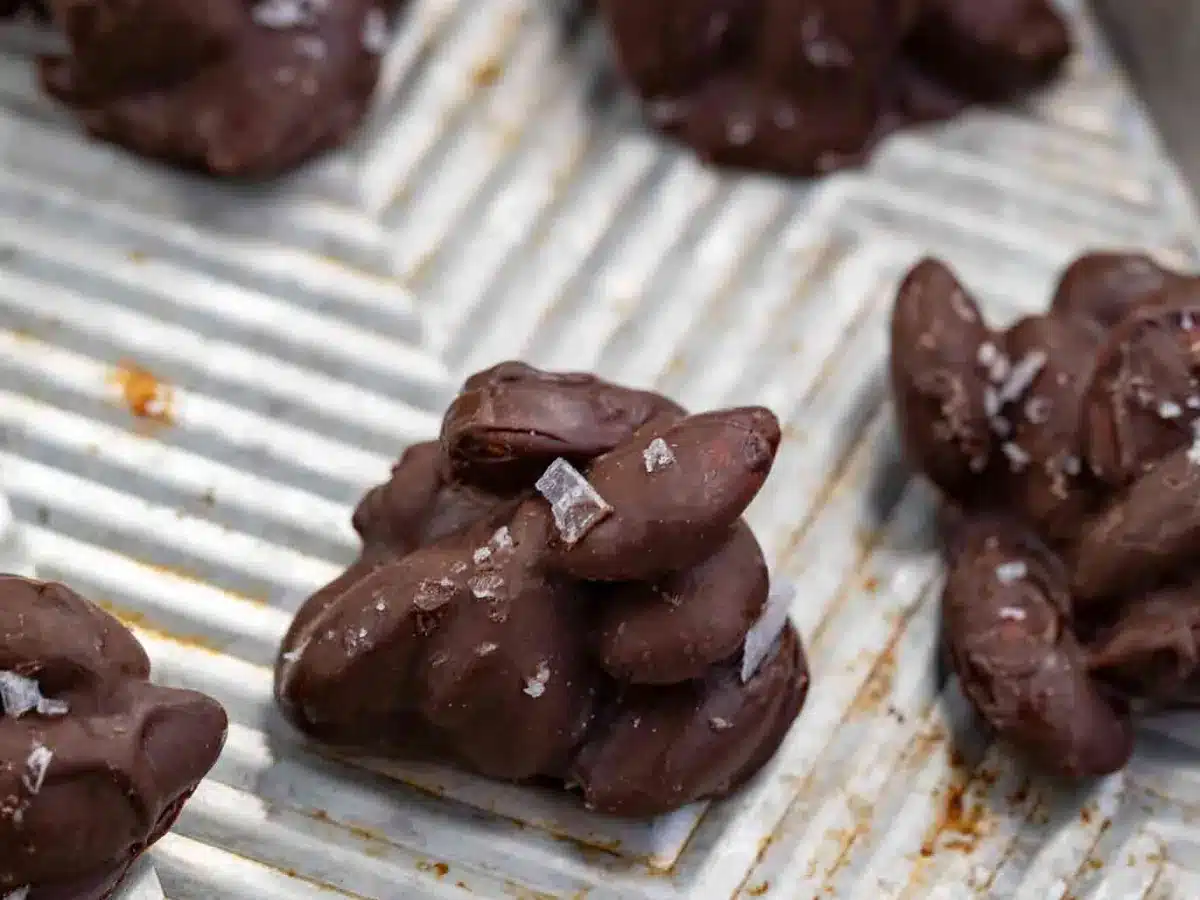 Cluster of almonds coated in chocolate and flakey salt ganish