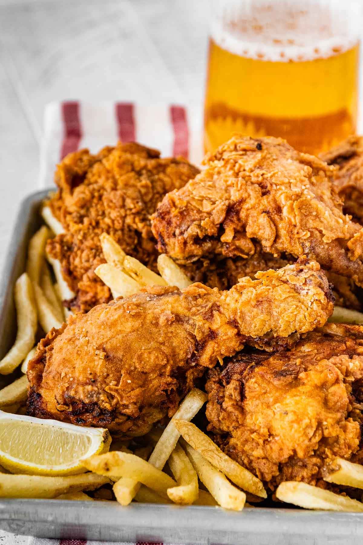 Super Crispy Fried Chicken with french fries and lemon wedge