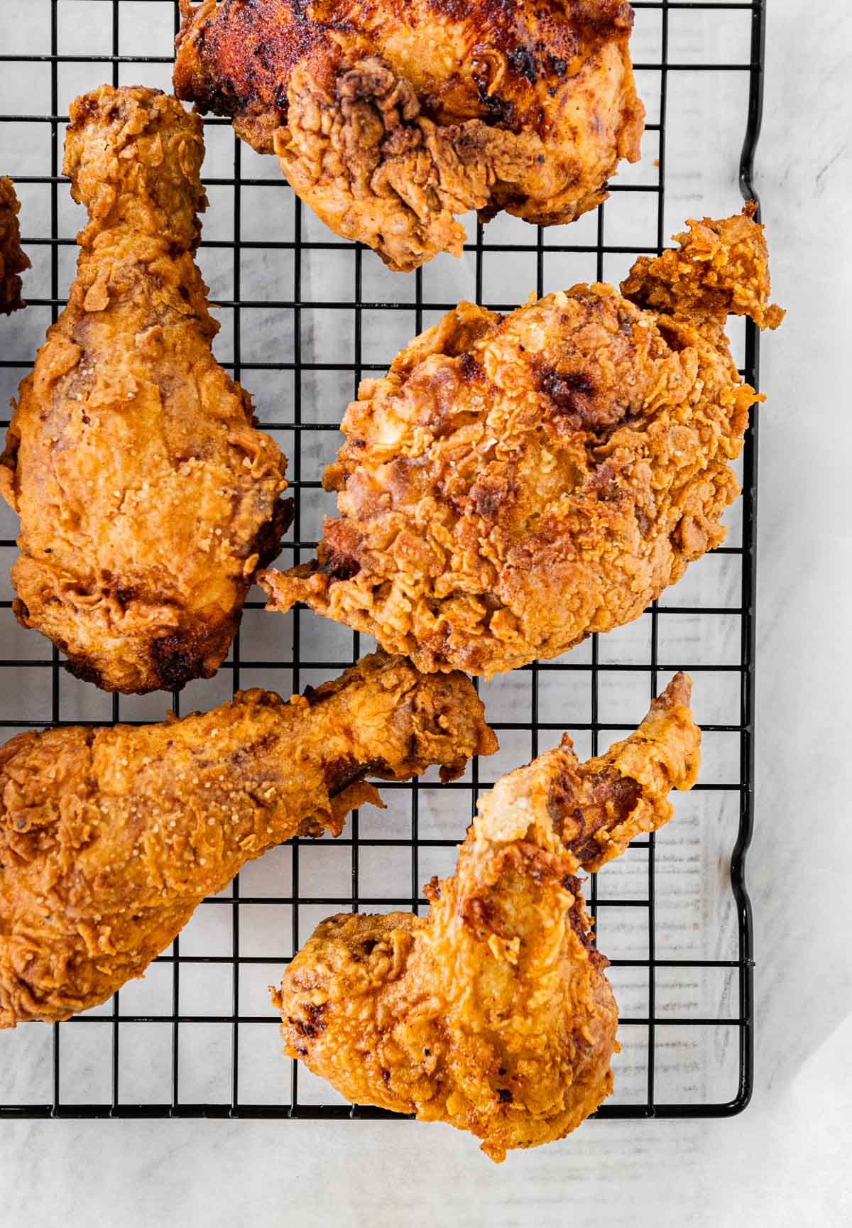 Super Crispy Fried Chicken pieces on wire rack