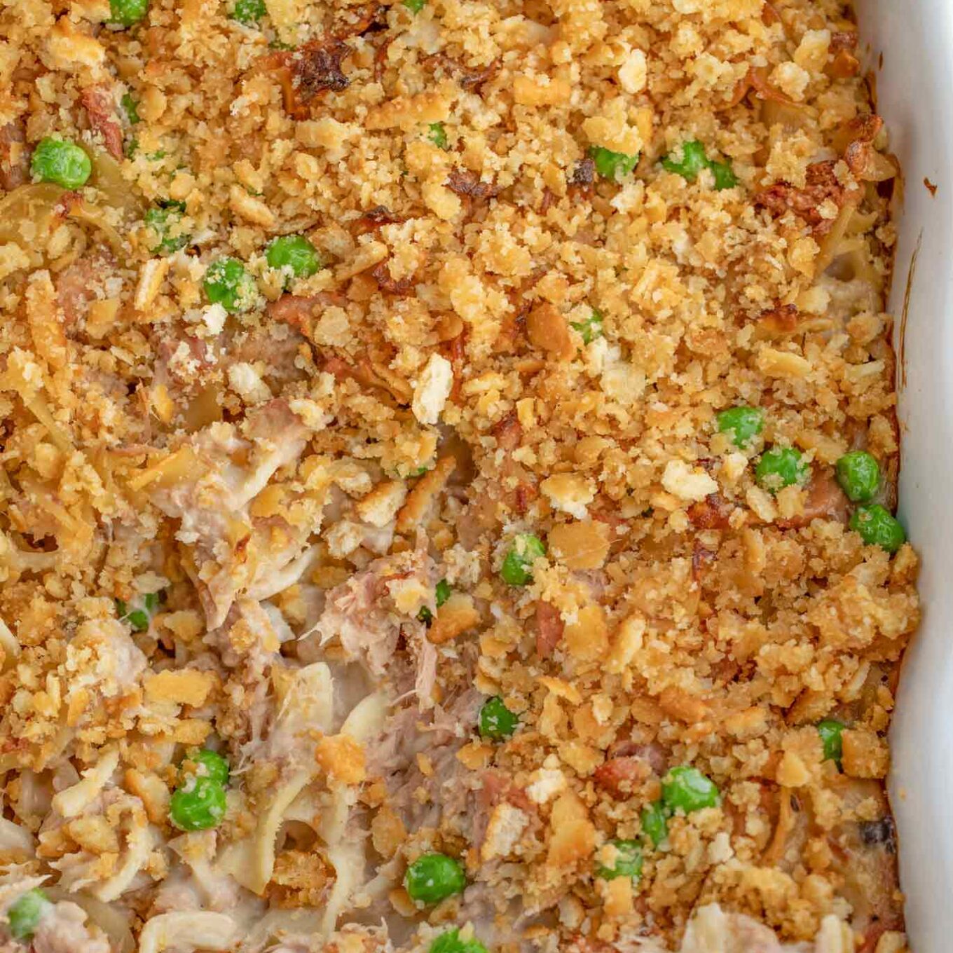 Baked casserole in baking pan with filling showing.
