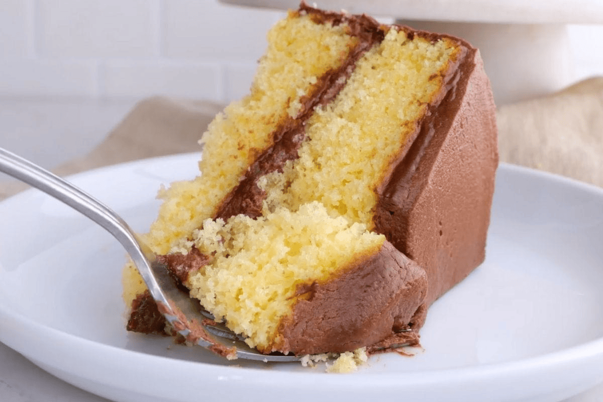 Slice of cake with spoon taking a bite