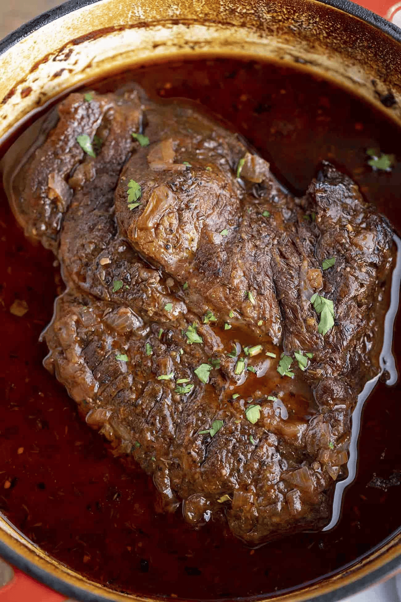 Chuck roast cooking in wine sauce
