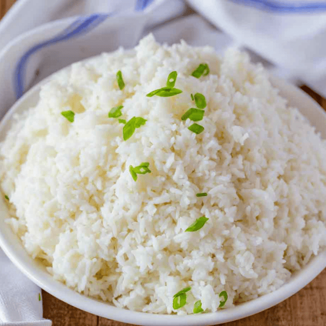 Bowl of cooked rice in bowl garnished with chives