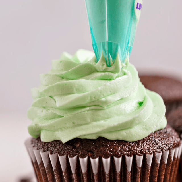 green buttercream piped onto a cupcake