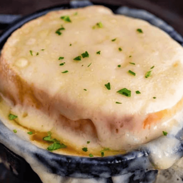 onion soup topped with bread and cheese in bowl