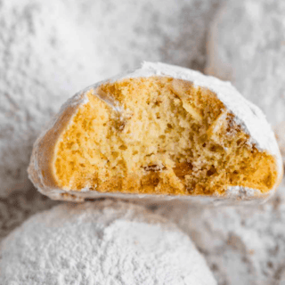 cookie covered in white powdered sugar bitten in half