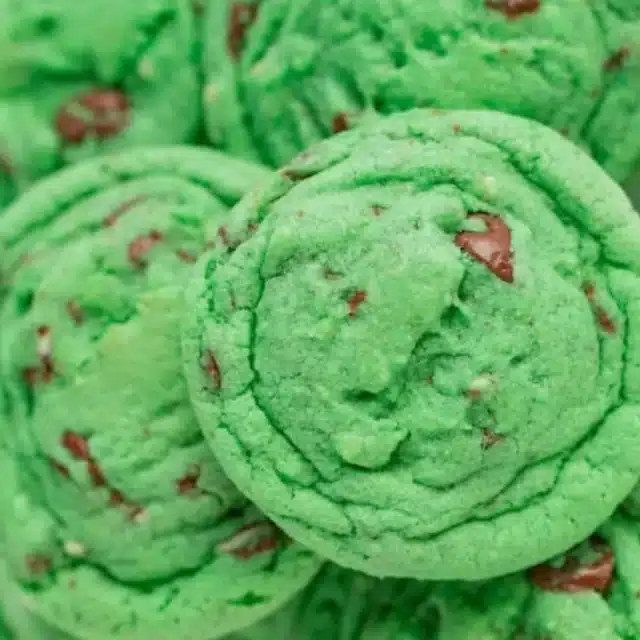 Green cookies with chocolate chips piled together