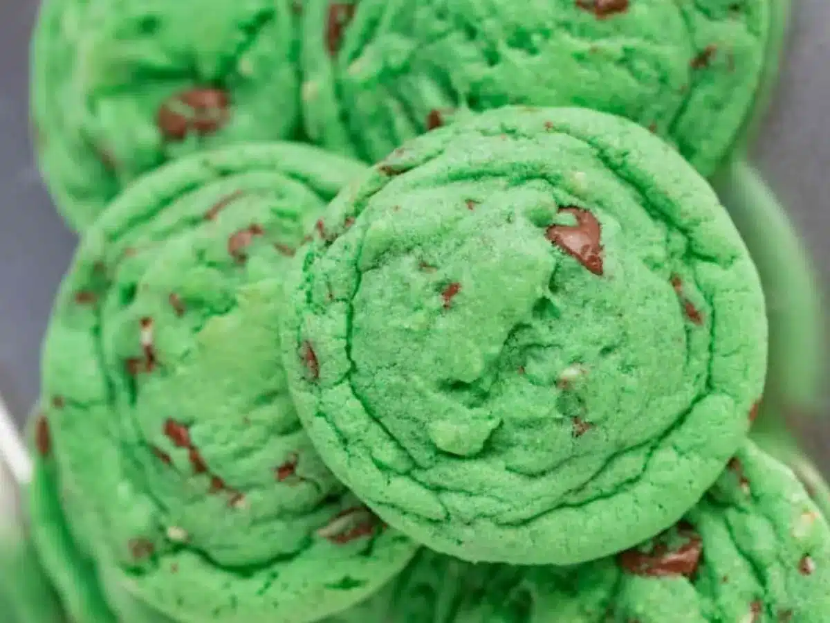 Green cookies with chocolate chips piled together