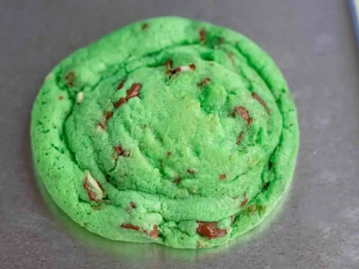 Green cookie with chocolate chips on tray