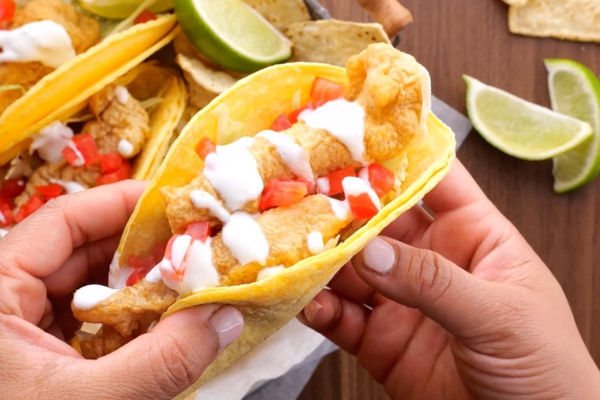 Beer Battered Crispy Fish Tacos held by hands