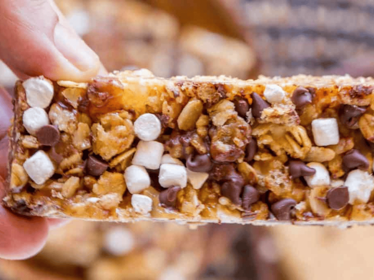 Fingers holding a snack bar