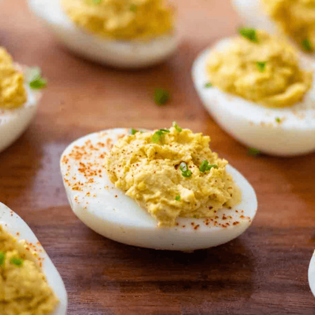 Eggs with filling lined up on serving tray