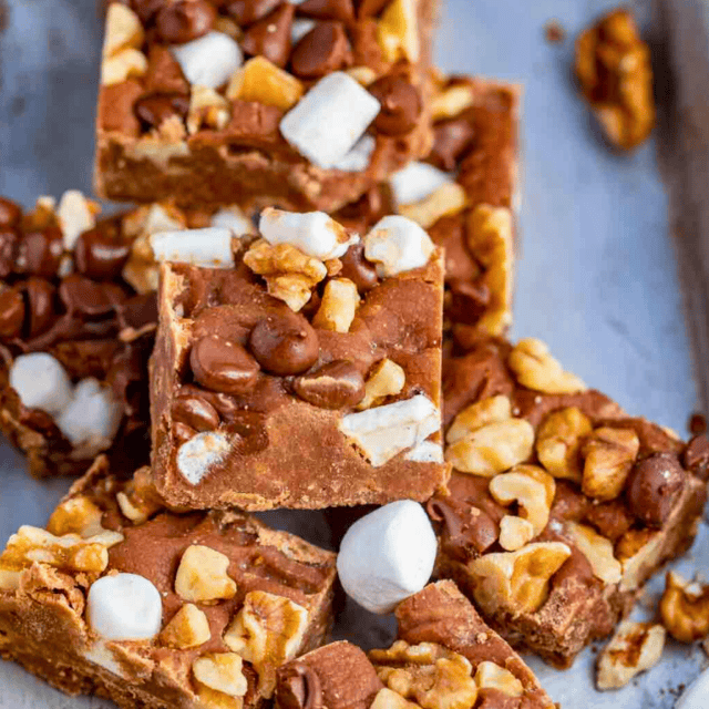 chocolate square with walnuts, marshmallows, and chocolate chips on top stacked on one another