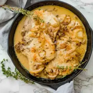 Top view of pork in pan smothered
