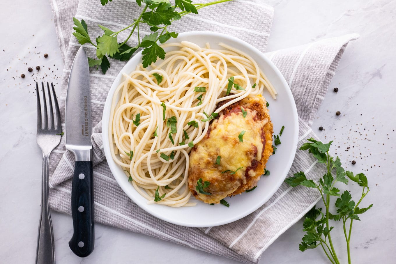 Easy Chicken Parmesan on plate with pasta