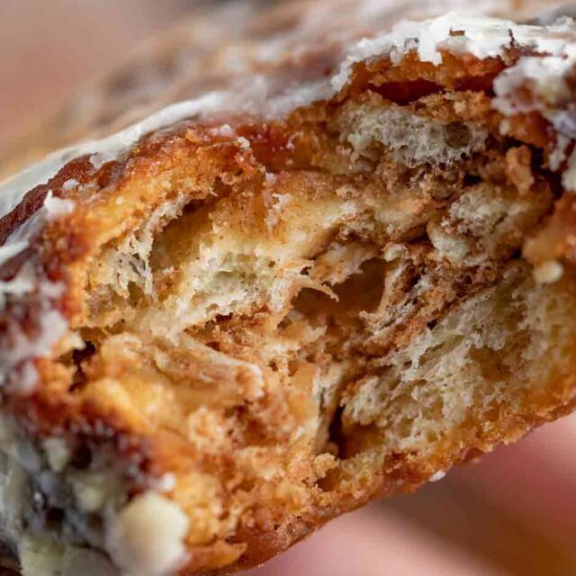Bite of apple pastry with sugar glaze