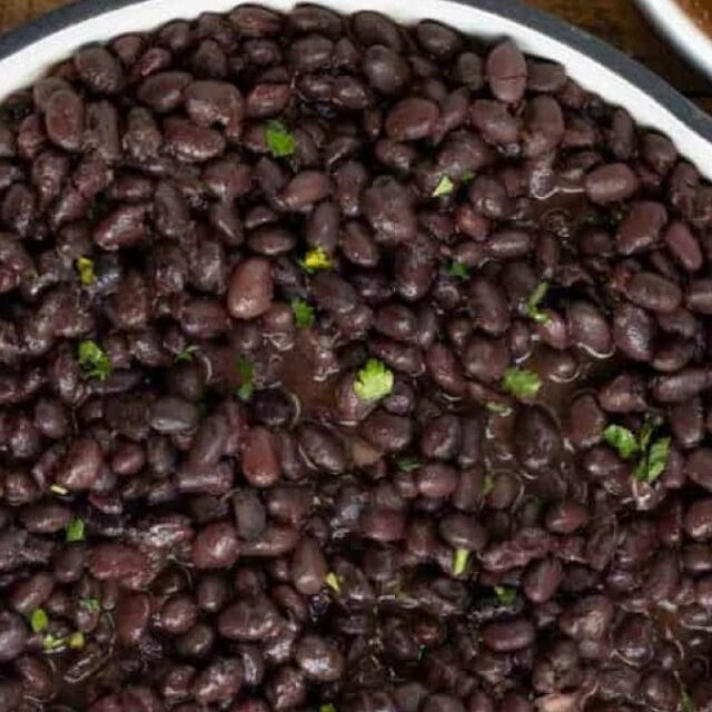Black Beans in a pot with Salsa on this side.