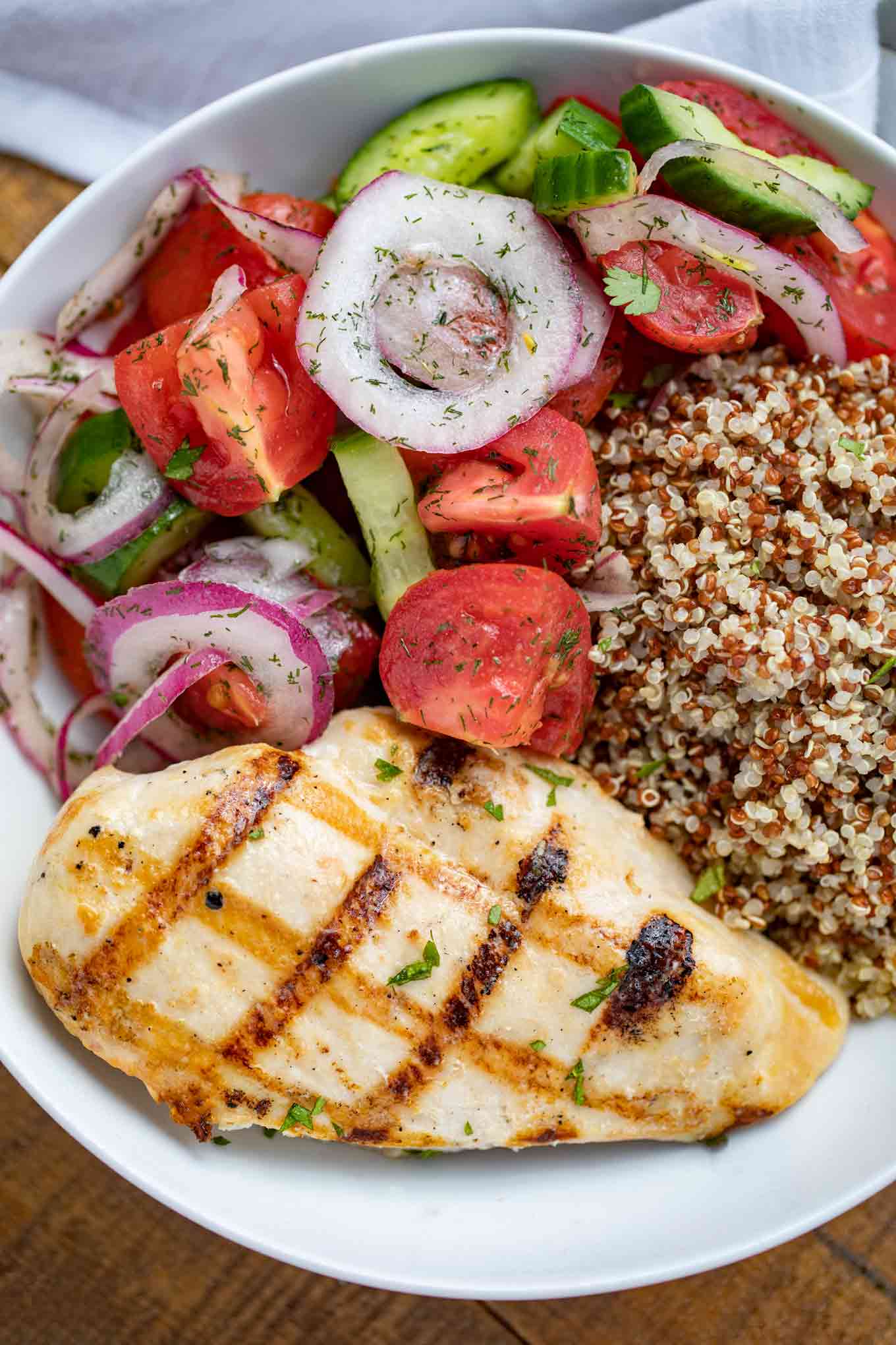 Grilled Chicken with Cucumber Tomato Salad and Quinoa in bowl