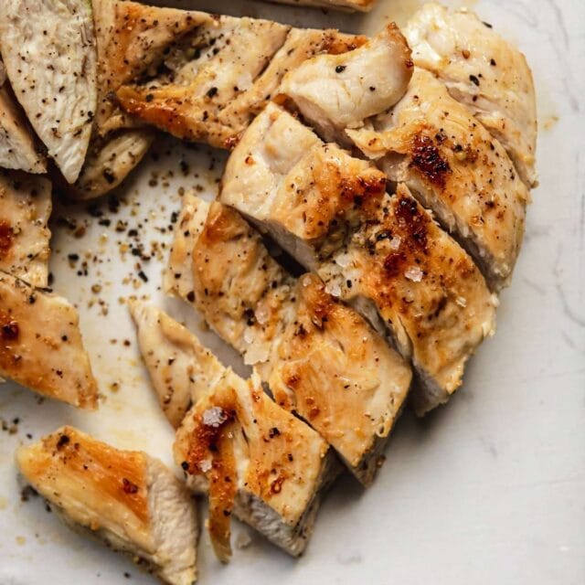 Grilled Chicken sliced on cutting board