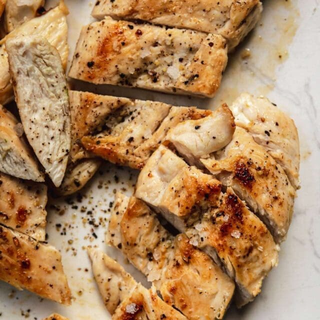 Grilled Chicken sliced on cutting board