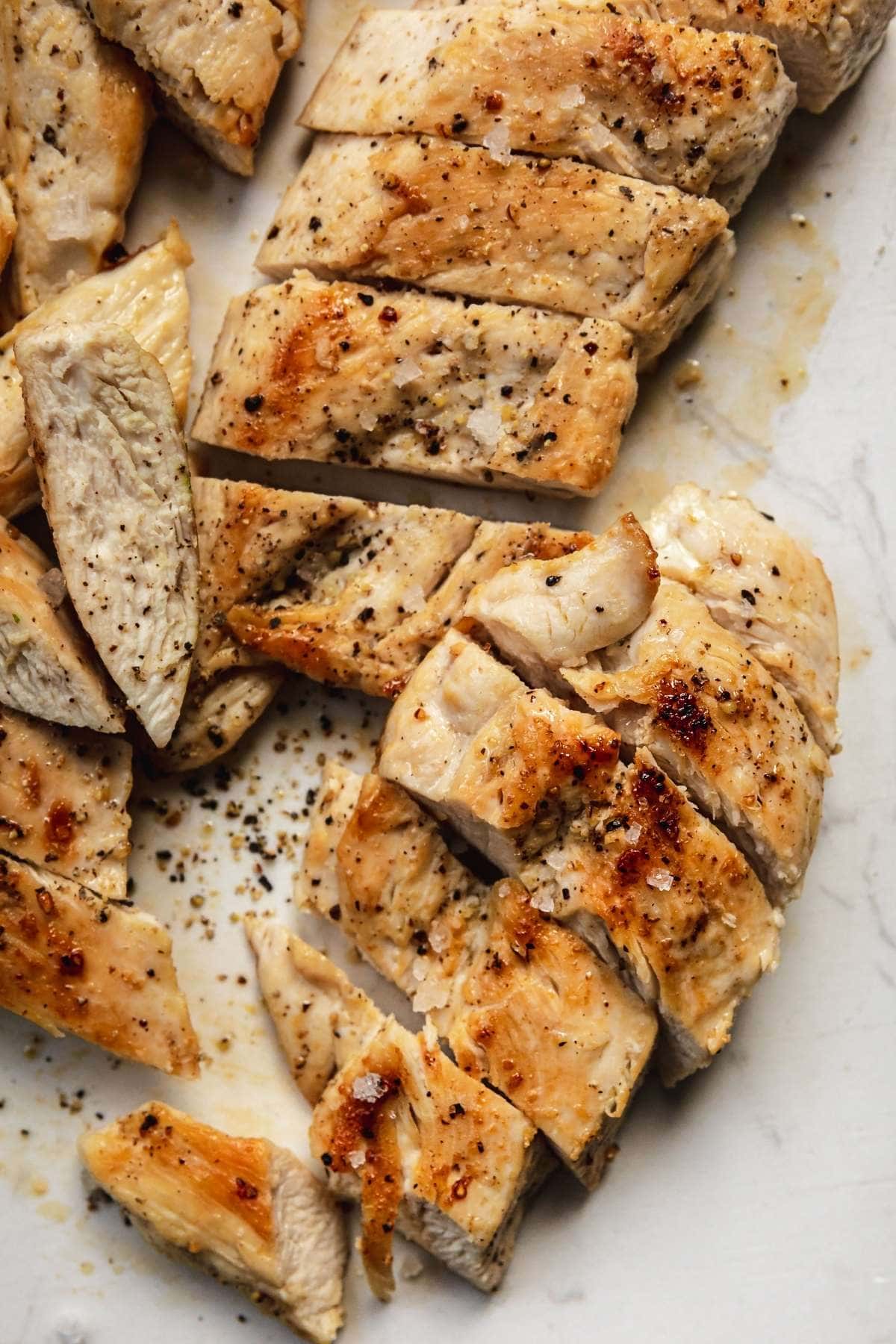 Grilled Chicken sliced on cutting board