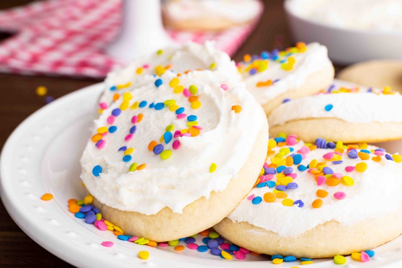 Lofthouse Sugar Cookies with white frosting and colorful sprinkles on plate