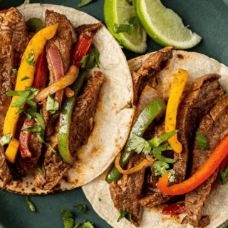plated steak and veggies on tortillas